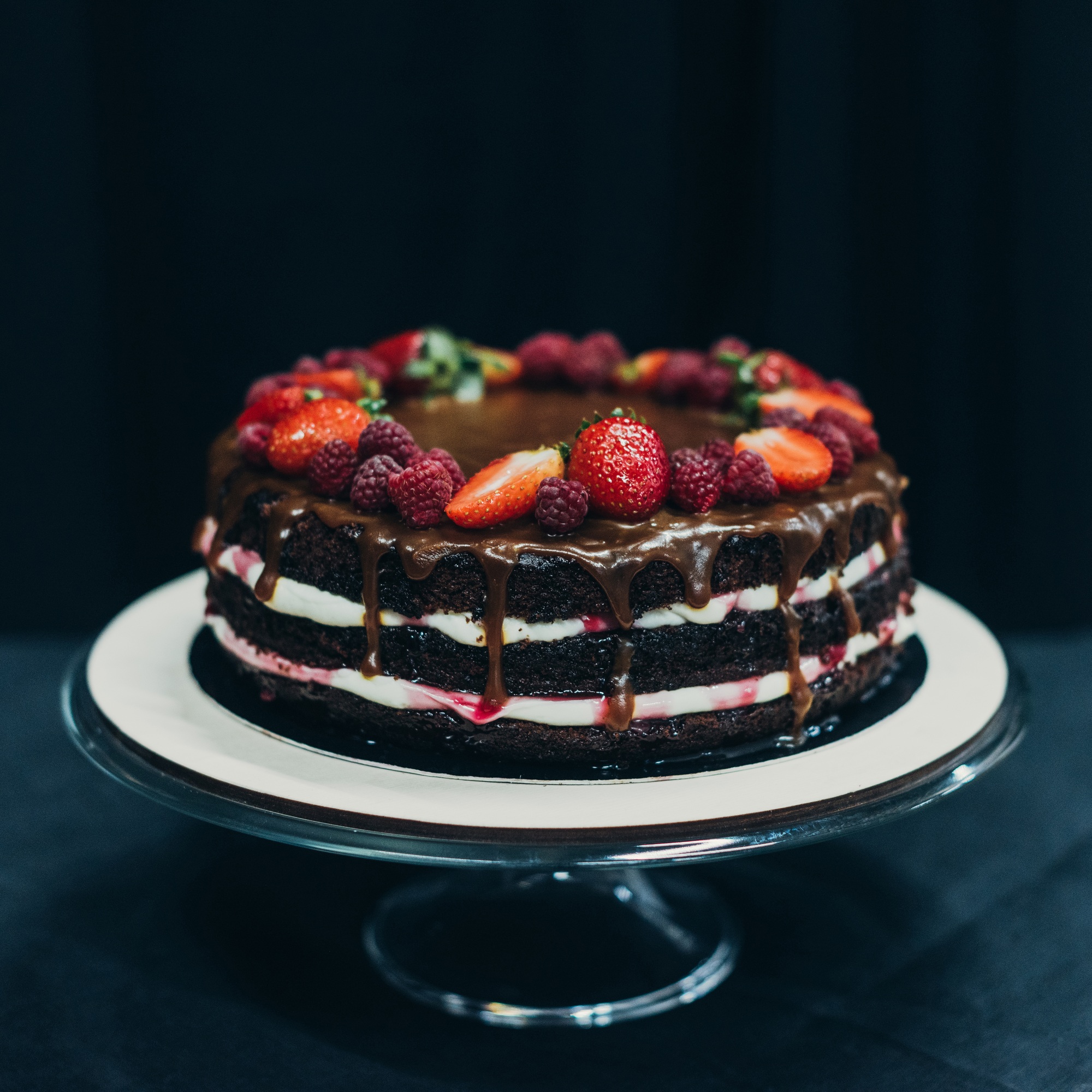 Chocolate creamy cake with strawberries and raspberries